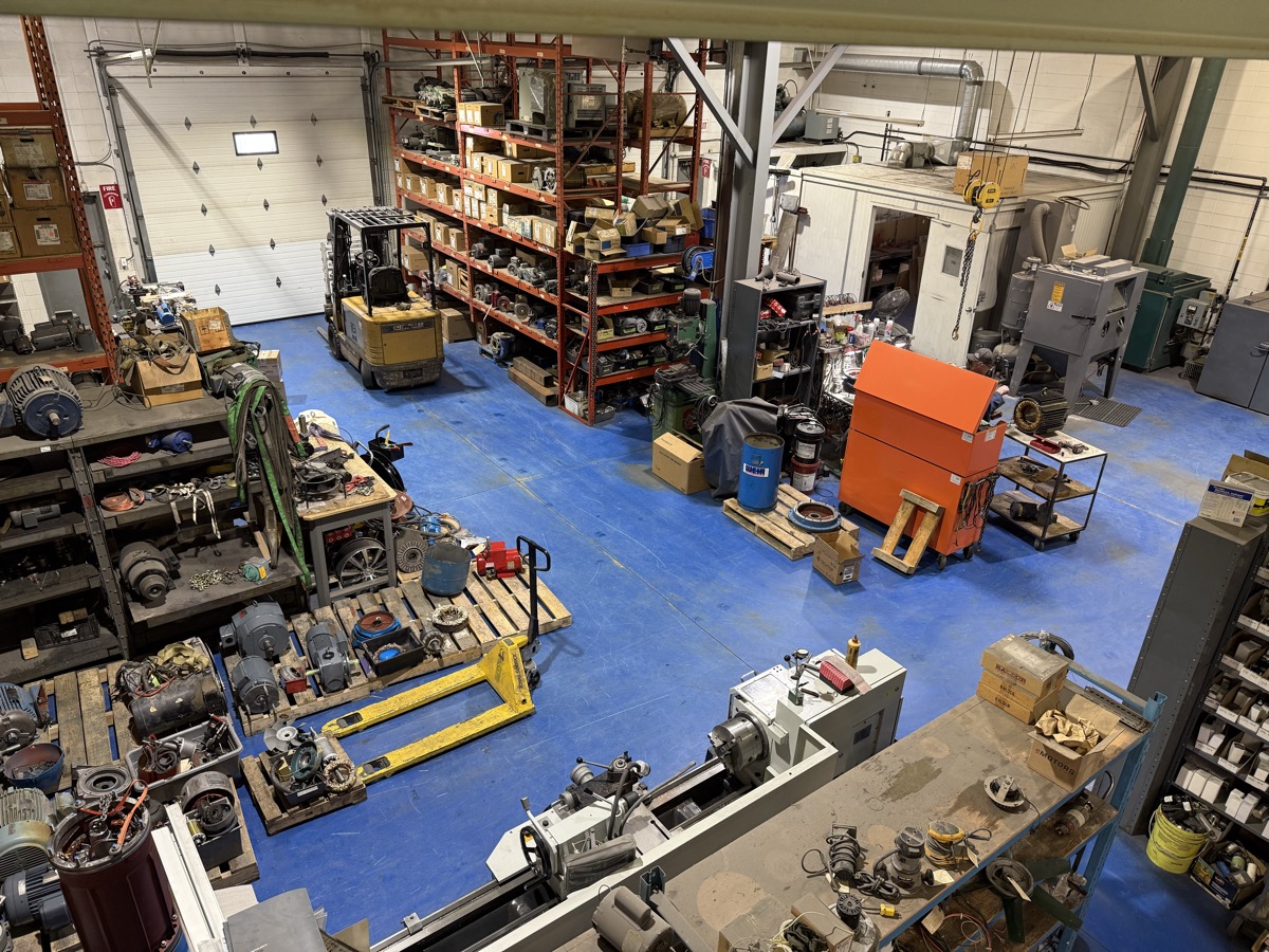 Overhead view of Complete Electric motor repair shop floor showing lathe, crane, and motors in Calgary
